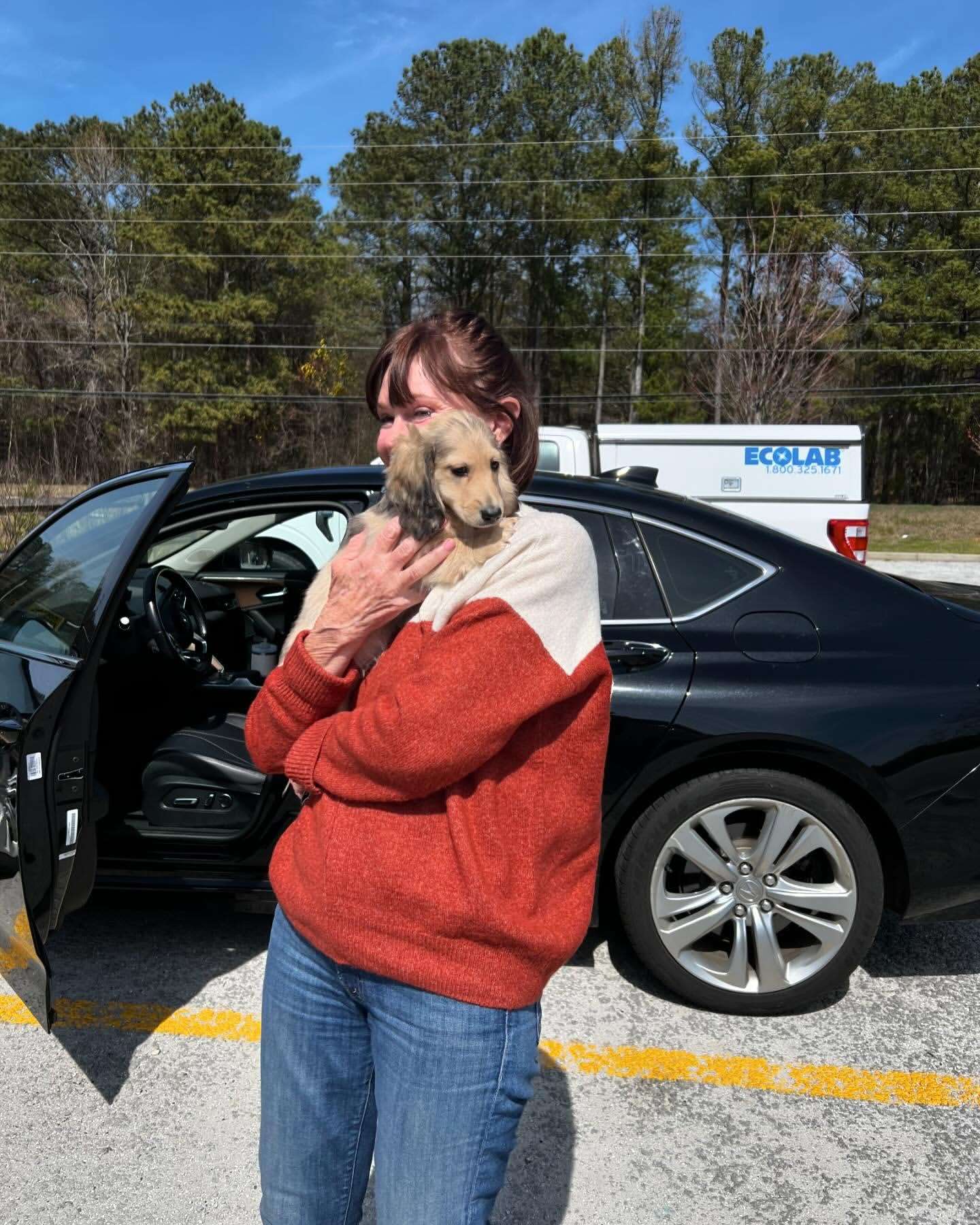Happy family with their Dachshund puppy