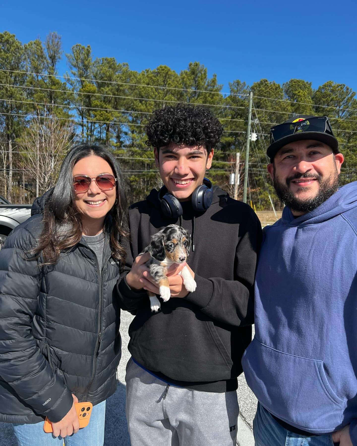 Happy family with their Dachshund puppy