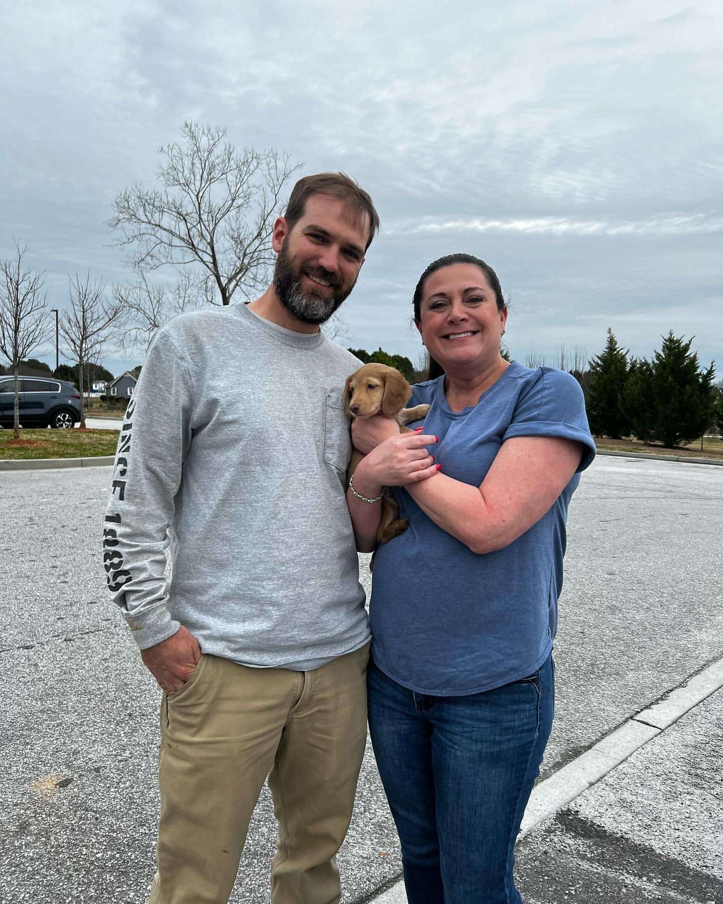 Happy family with their Dachshund puppy