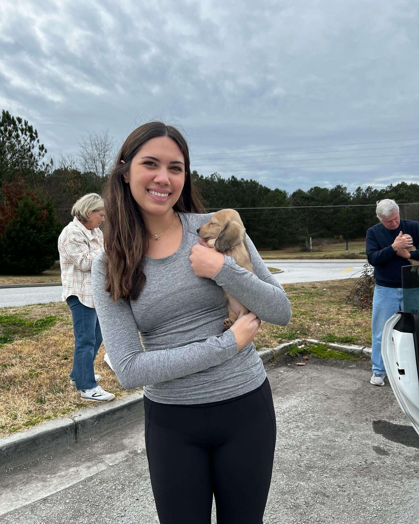 Happy family with their Dachshund puppy