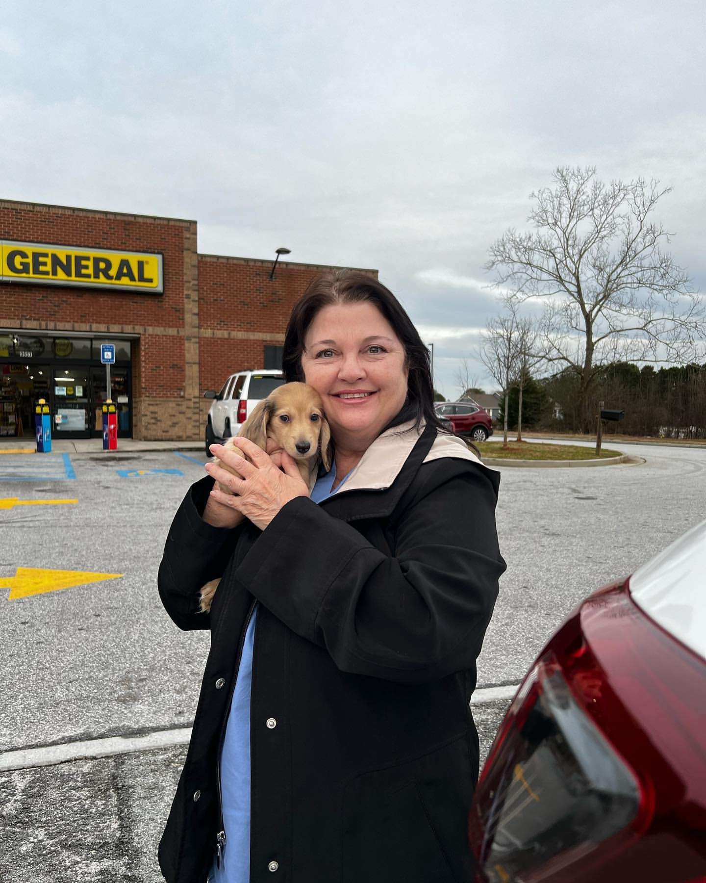 Happy family with their Dachshund puppy
