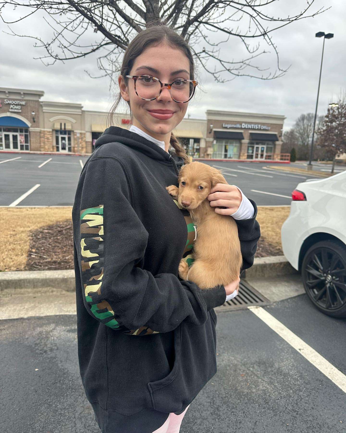 Happy family with their Dachshund puppy