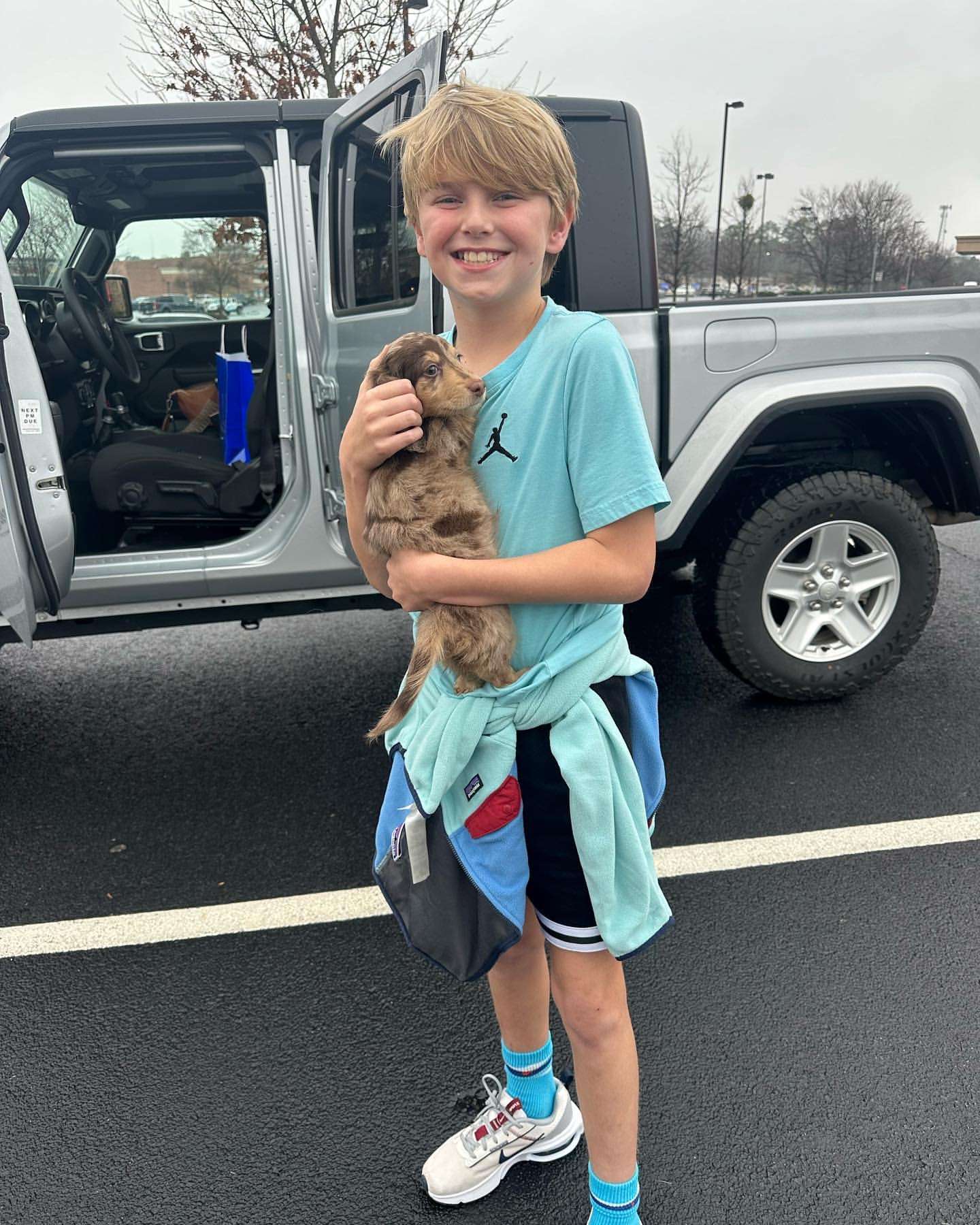 Happy family with their Dachshund puppy