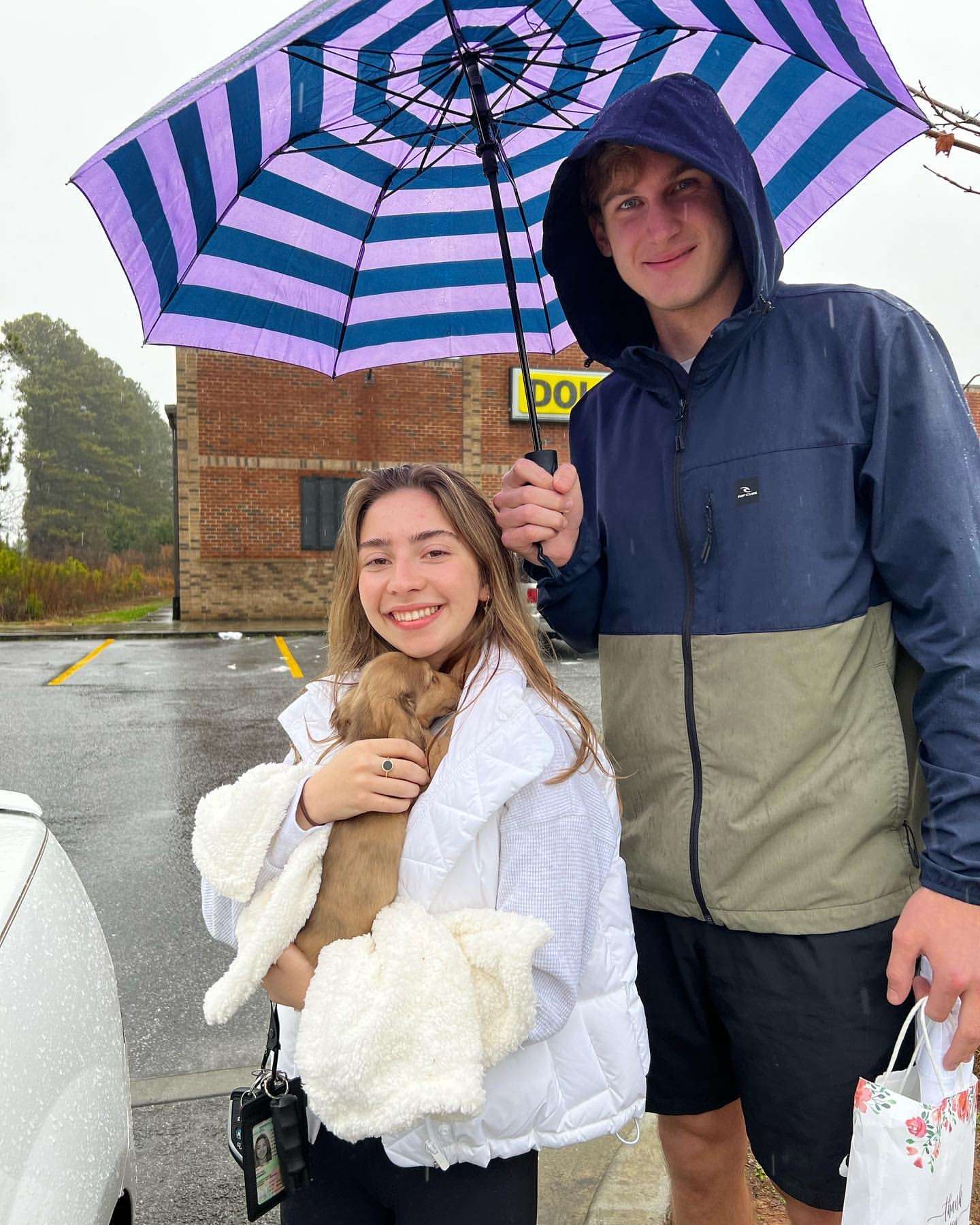 Happy family with their Dachshund puppy