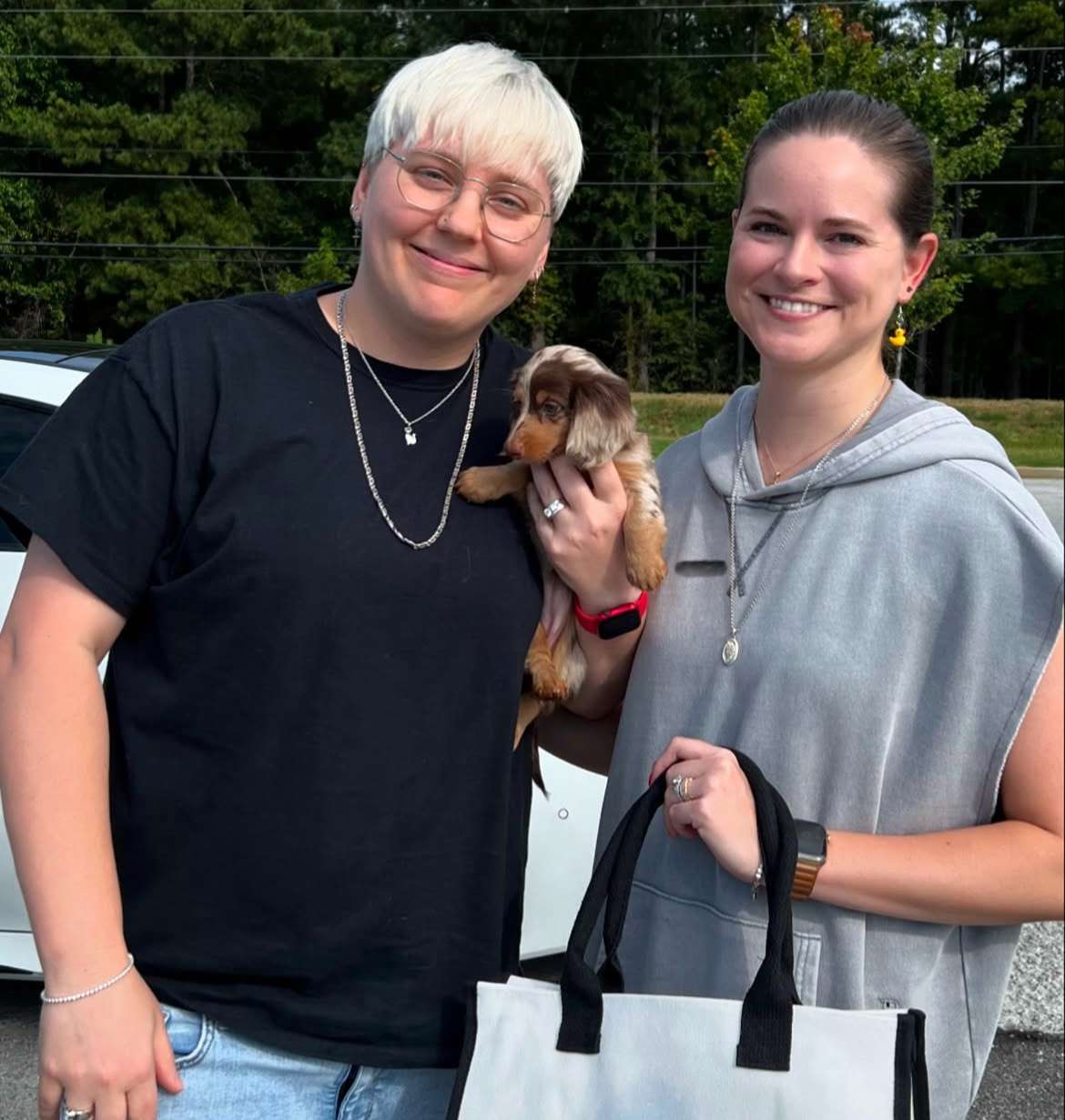 Happy family with their Dachshund puppy