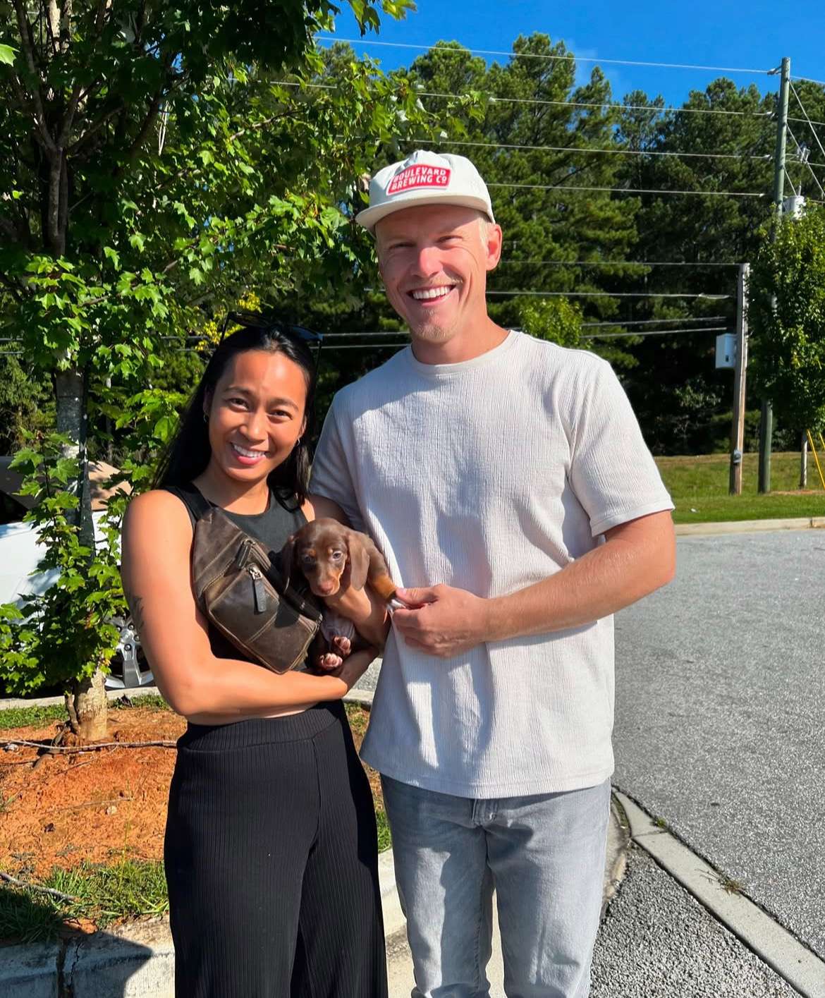 Happy family with their Dachshund puppy