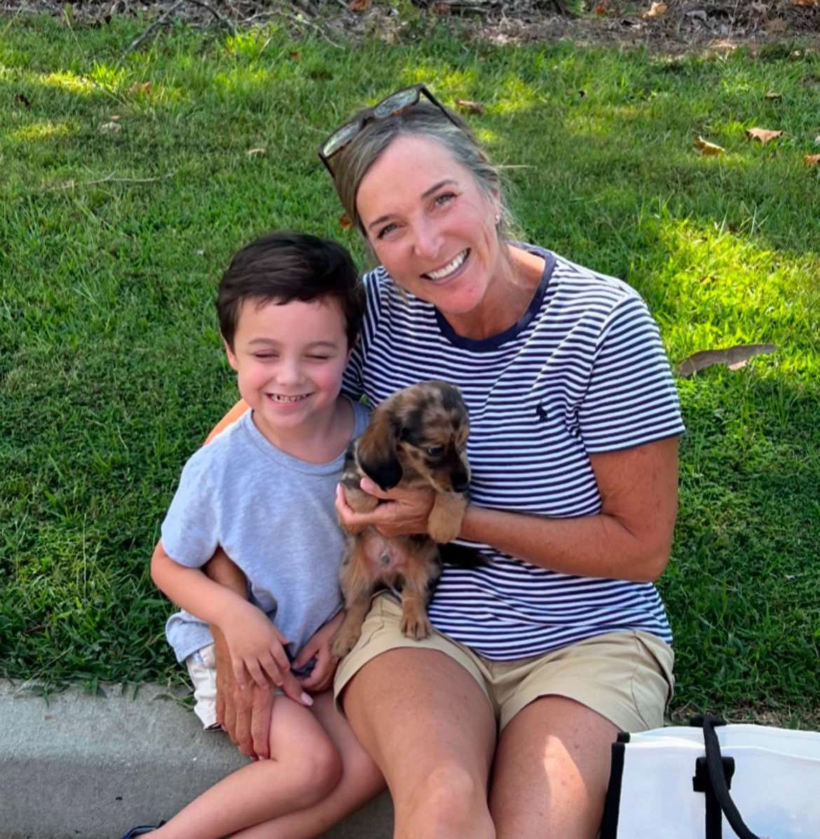 Happy family with their Dachshund puppy