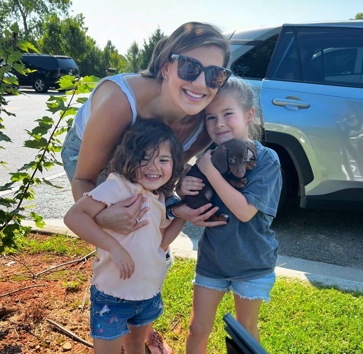 Happy family with their Dachshund puppy