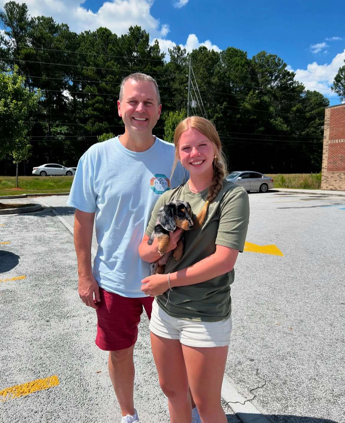 Happy family with their Dachshund puppy